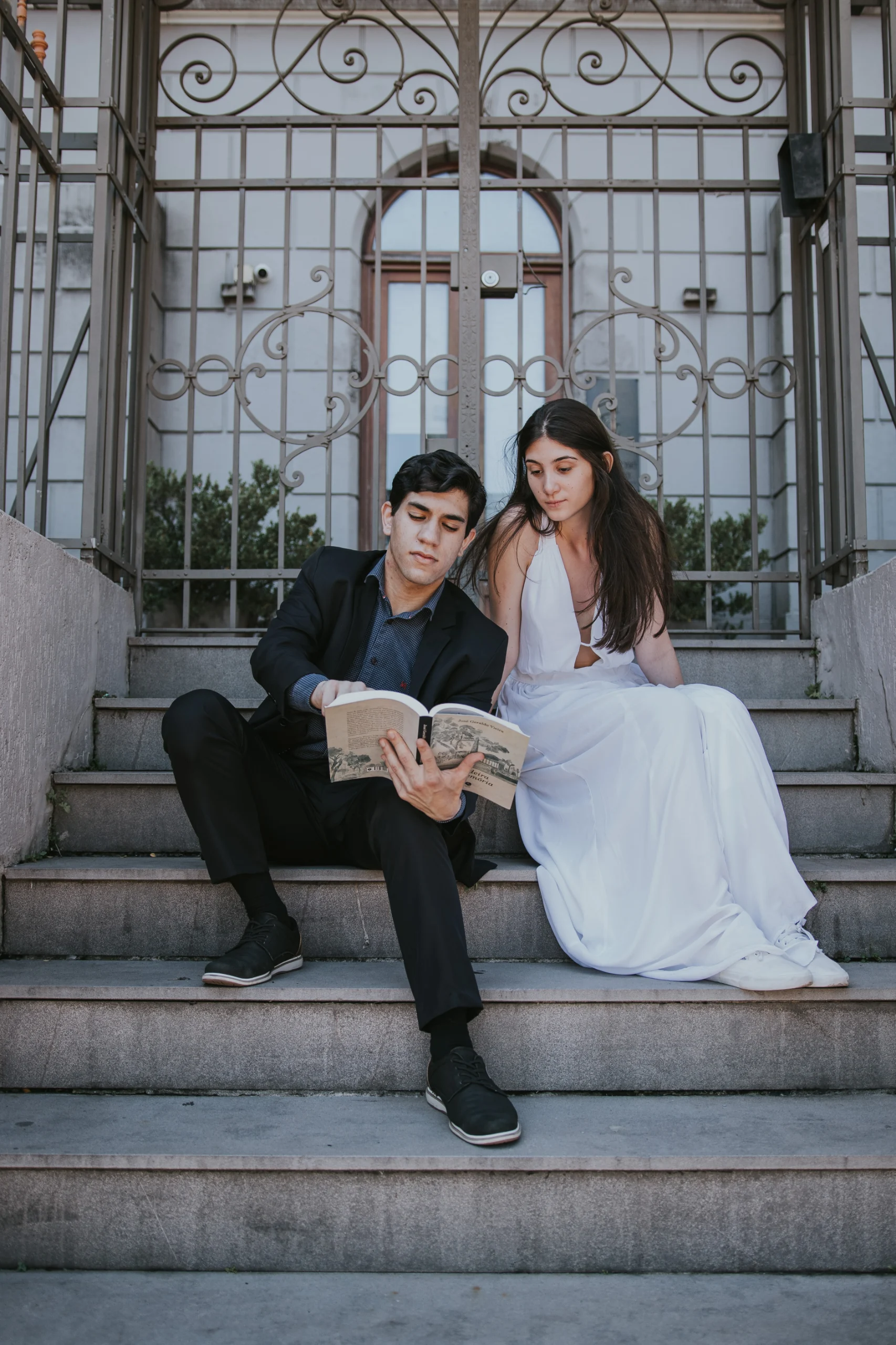 O autor e Mariana, sentados à escada, lendo juntos.